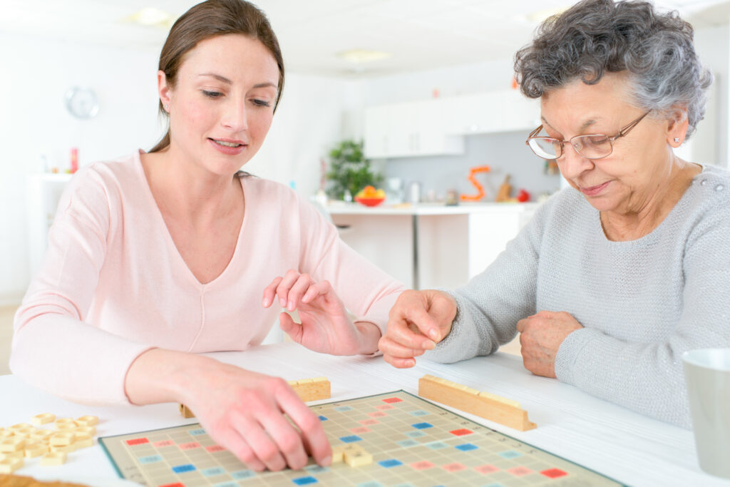 Young woman and senior woman playing board game